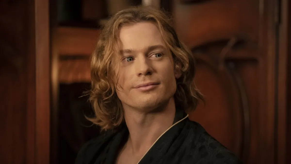 A man with long blond hair and strange blue eyes
