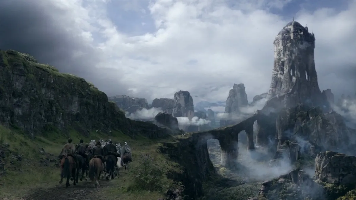 A cavalcade of horsemen ride towards a castle in the mountains in "Game of Thrones"