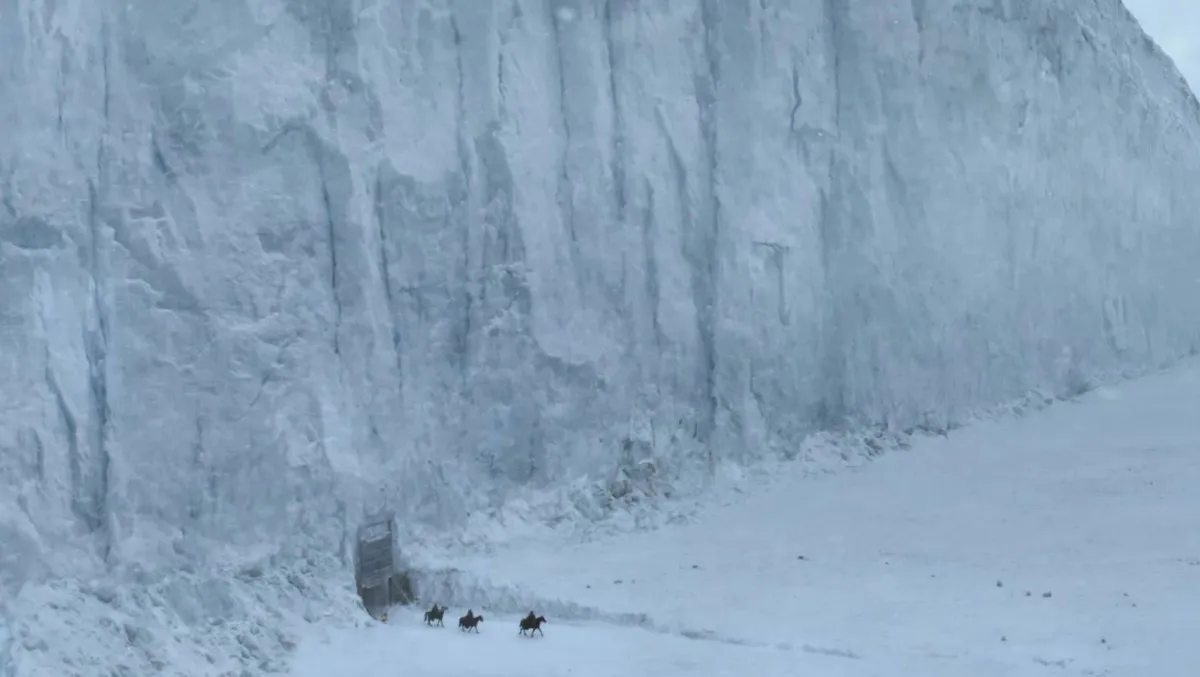 Horsemen ride out from under a wall of ice in "Game of Thrones"