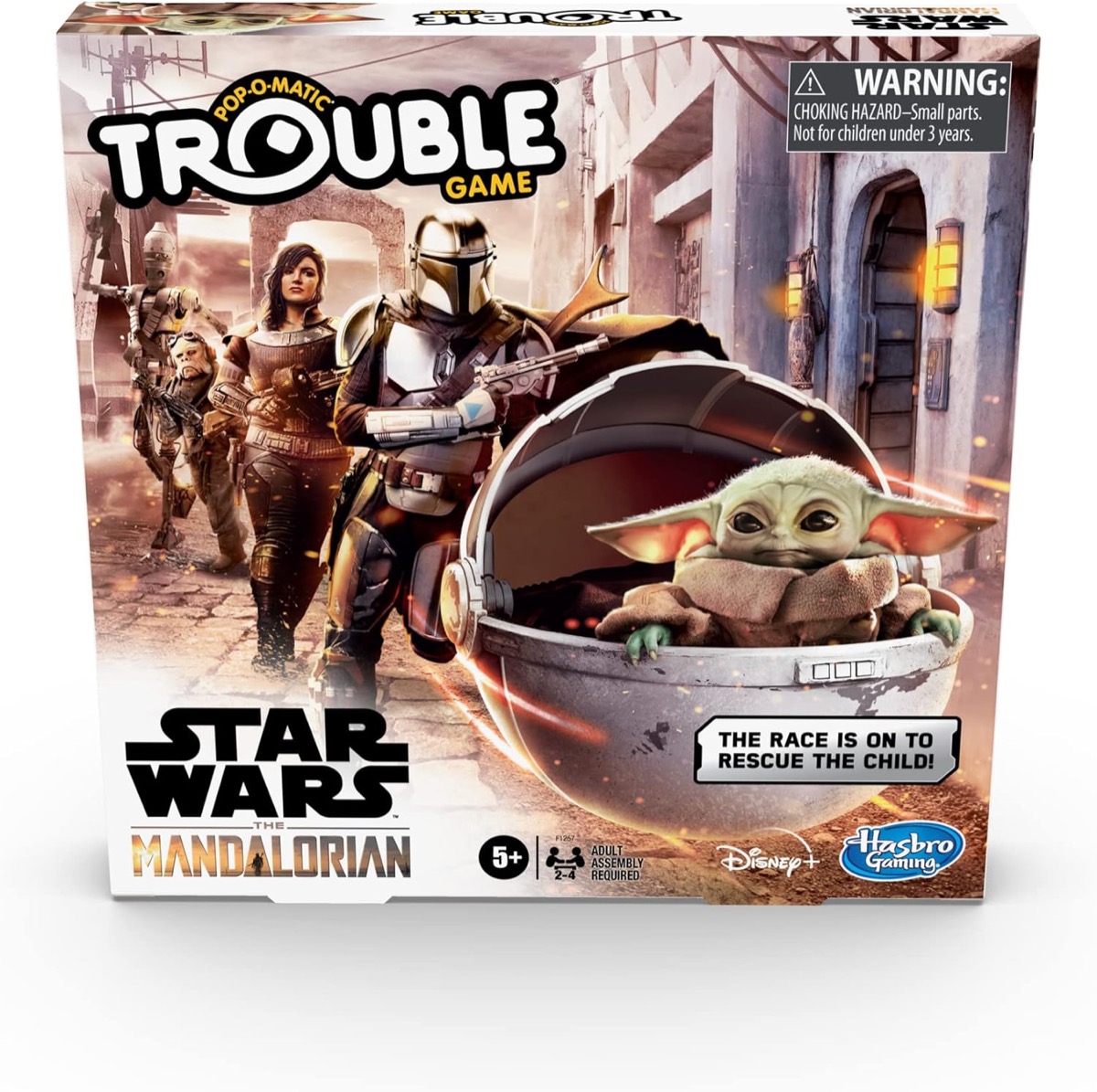 Box art for Trouble- Star Wars The Mandalorian Edition featuring The Child being chased by Mando and a comrade