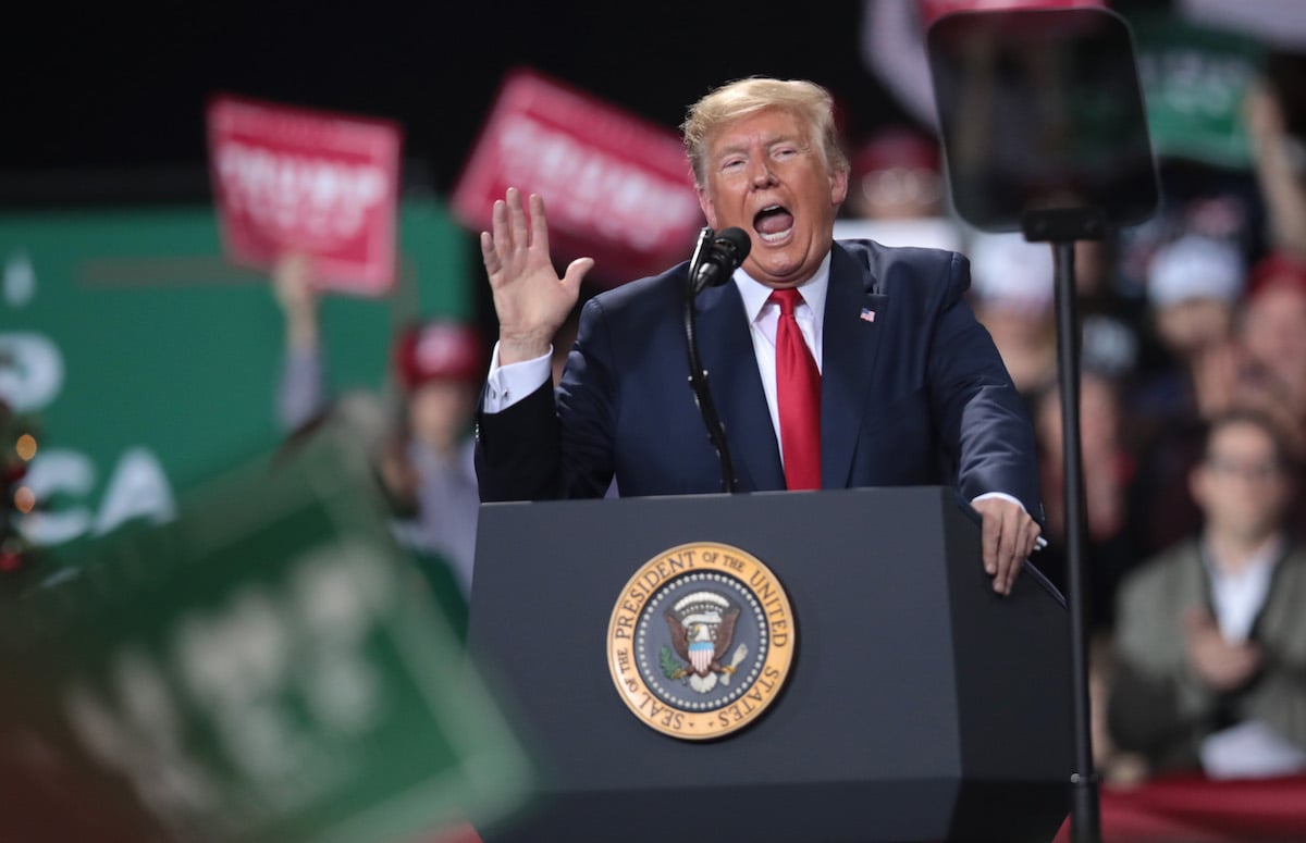 Trump yells from the stage at a rally.